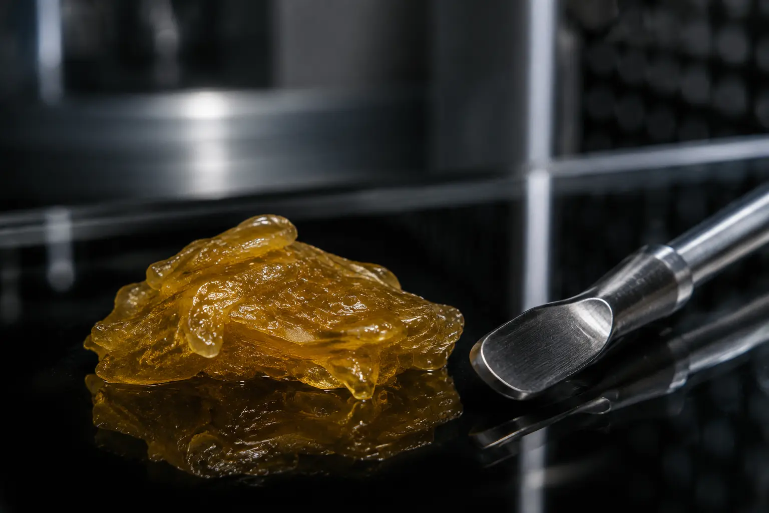 Conceptual close-up of solventless rosin and a stainless steel tool